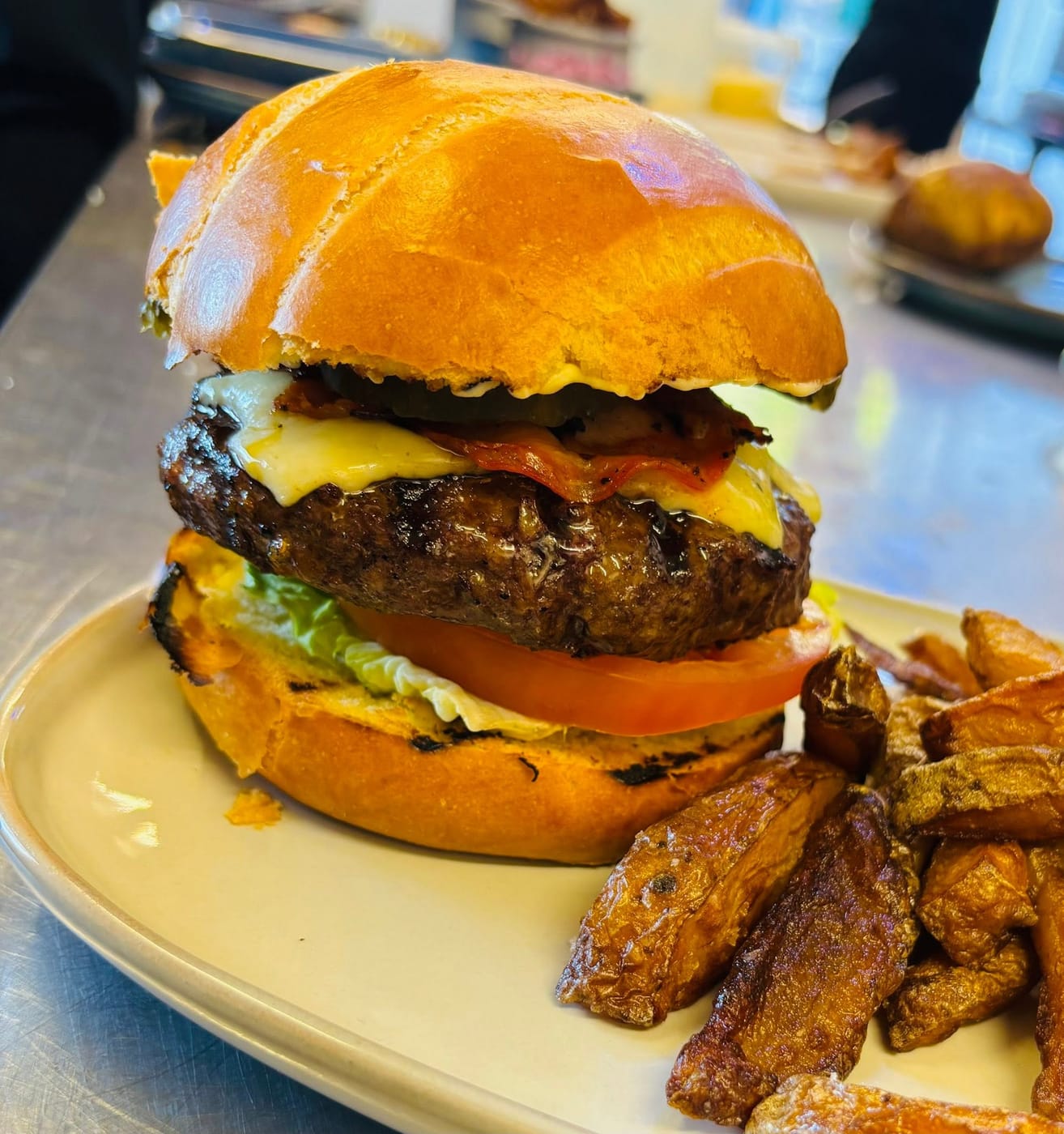 Handmade gourmet burger with melted cheese and chunky chips